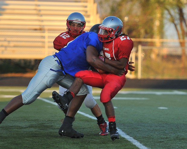 Lake Central's Gelen Robinson drills Morton’s Avante Scott on Friday night.